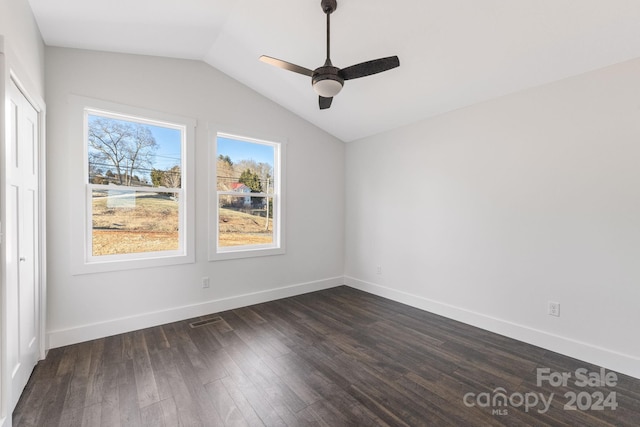 empty room with dark hardwood / wood-style floors, ceiling fan, and lofted ceiling