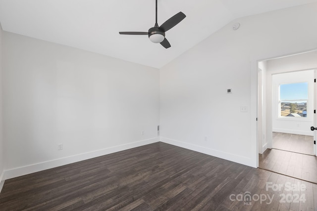 spare room featuring ceiling fan, dark wood-type flooring, and vaulted ceiling