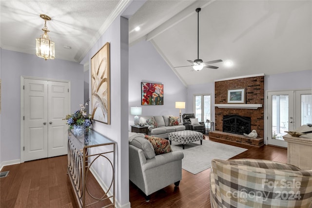 living room featuring french doors, ceiling fan with notable chandelier, a fireplace, beamed ceiling, and dark hardwood / wood-style flooring