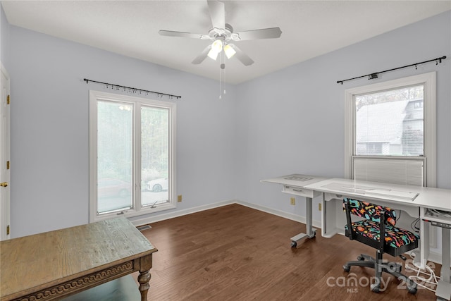 office featuring a wealth of natural light, ceiling fan, and dark hardwood / wood-style floors