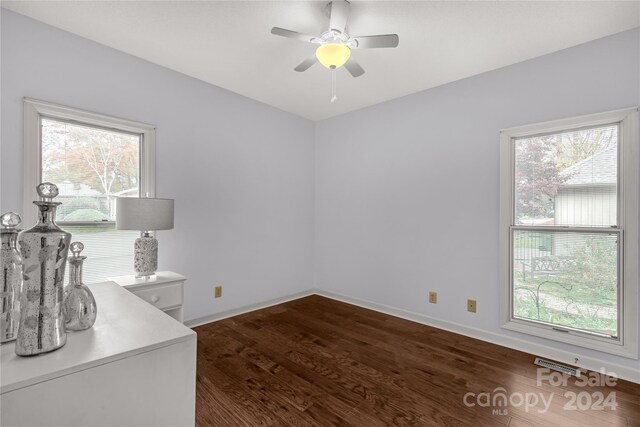 office area featuring dark hardwood / wood-style flooring, ceiling fan, and plenty of natural light