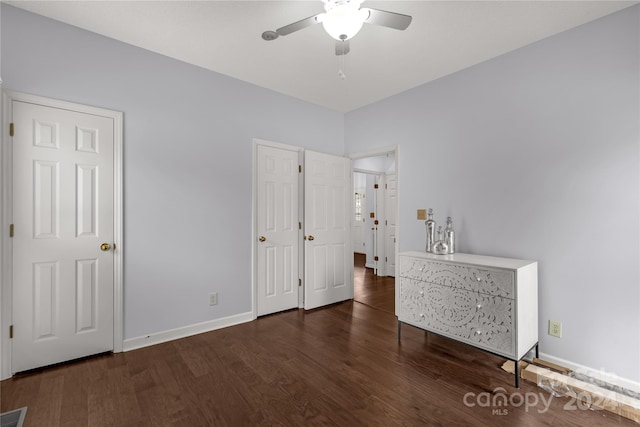 unfurnished bedroom with ceiling fan and dark hardwood / wood-style flooring