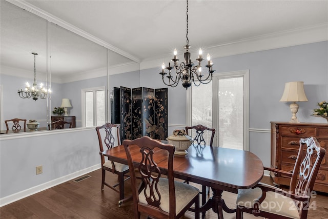 dining area with crown molding, dark wood-type flooring, and an inviting chandelier