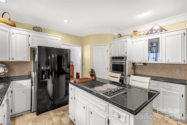 kitchen featuring stovetop, black fridge with ice dispenser, white cabinets, and a kitchen island