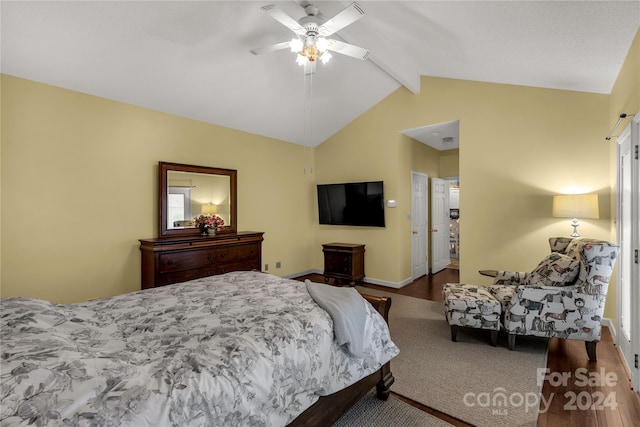 bedroom featuring hardwood / wood-style floors, vaulted ceiling with beams, and ceiling fan