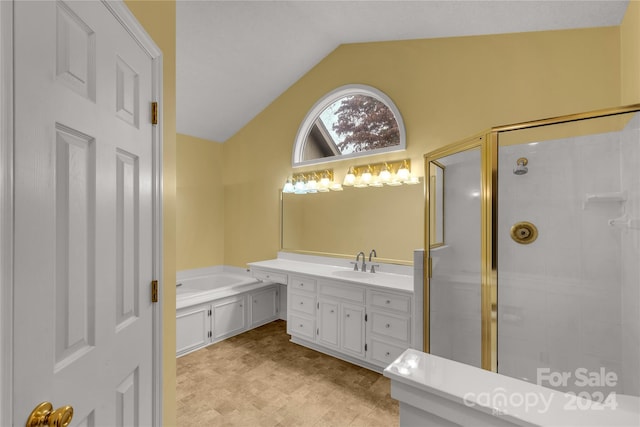 bathroom featuring separate shower and tub, vanity, and vaulted ceiling