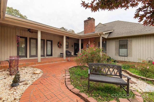 back of property with covered porch and ceiling fan