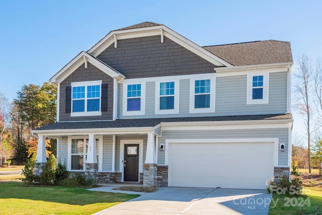 craftsman-style home with a front yard and a garage