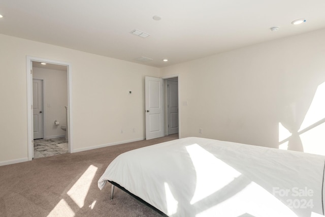 carpeted bedroom featuring ensuite bathroom