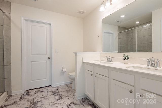 bathroom featuring walk in shower, vanity, and toilet