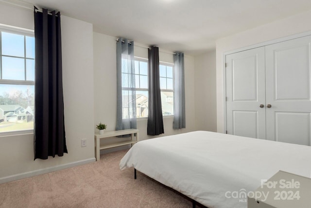 carpeted bedroom with a closet