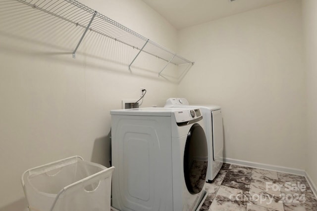 washroom with washer and dryer