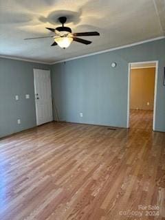 empty room featuring crown molding, ceiling fan, and light wood-type flooring