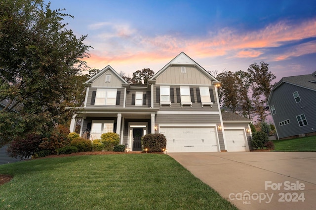 view of front of house featuring a garage and a yard