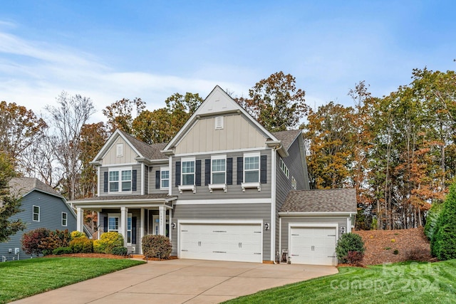 craftsman inspired home featuring a front yard and a garage