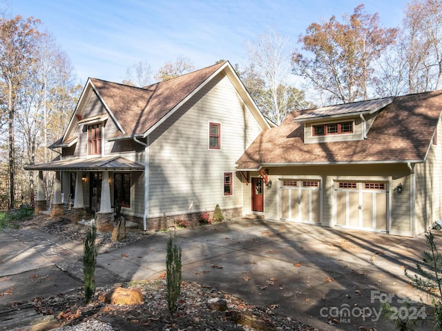 view of front facade featuring covered porch and a garage