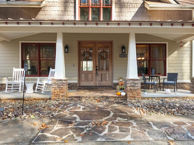 view of exterior entry with covered porch