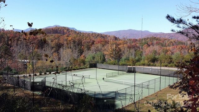 view of tennis court featuring a mountain view