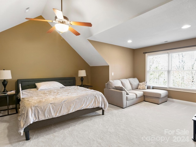 carpeted bedroom with ceiling fan and lofted ceiling