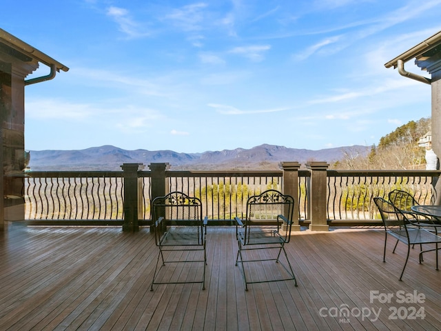 wooden deck with a mountain view