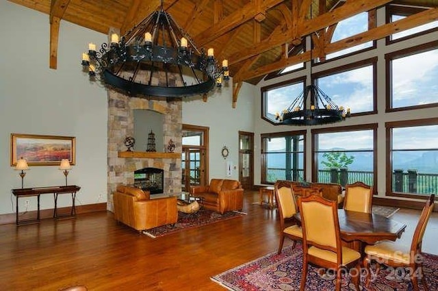 dining room featuring hardwood / wood-style floors, beamed ceiling, and high vaulted ceiling