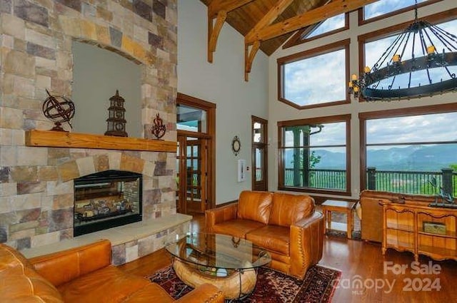 living room featuring wooden ceiling, high vaulted ceiling, beamed ceiling, hardwood / wood-style floors, and a fireplace