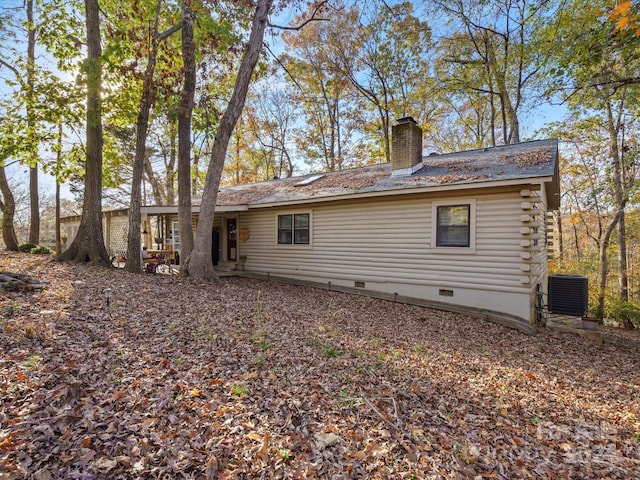 back of house with central AC unit