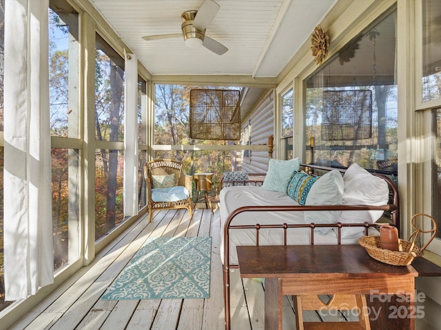 sunroom / solarium featuring ceiling fan