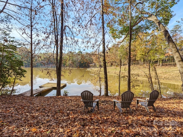 exterior space featuring a dock and a water view