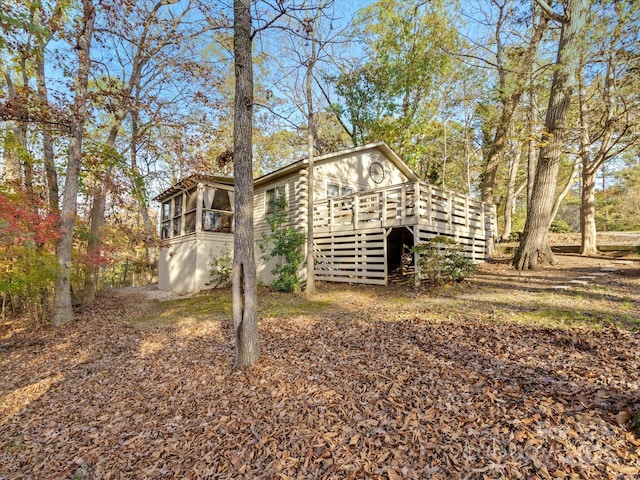view of outdoor structure featuring a sunroom and stairs