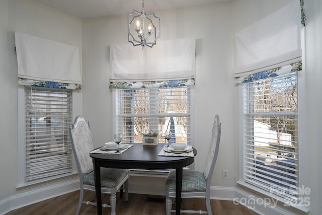 dining space with a chandelier and dark hardwood / wood-style floors