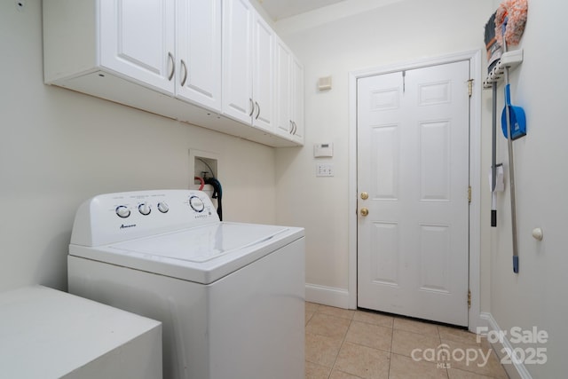 clothes washing area with washer / dryer, light tile patterned floors, and cabinets