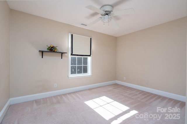 carpeted spare room with ceiling fan