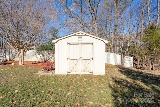 view of outbuilding featuring a lawn