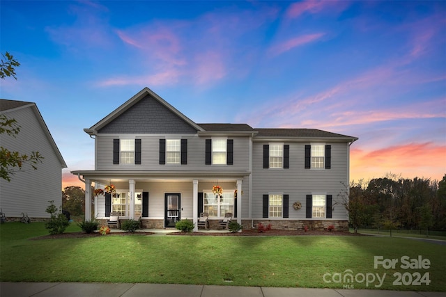 view of front of home featuring a yard and covered porch