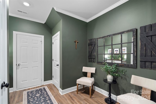 entrance foyer featuring hardwood / wood-style flooring and crown molding