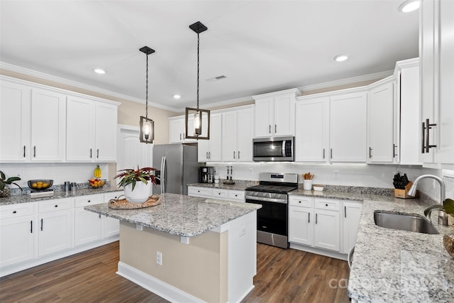 kitchen with dark wood-type flooring, sink, white cabinets, and stainless steel appliances