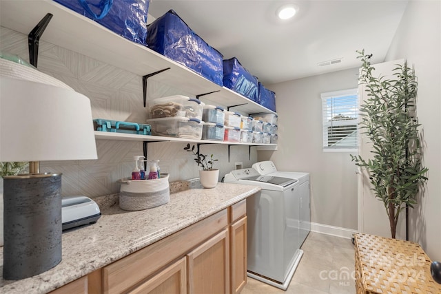 laundry area featuring independent washer and dryer and light tile patterned floors