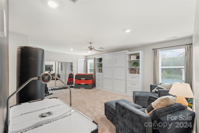 living room with ceiling fan and light carpet