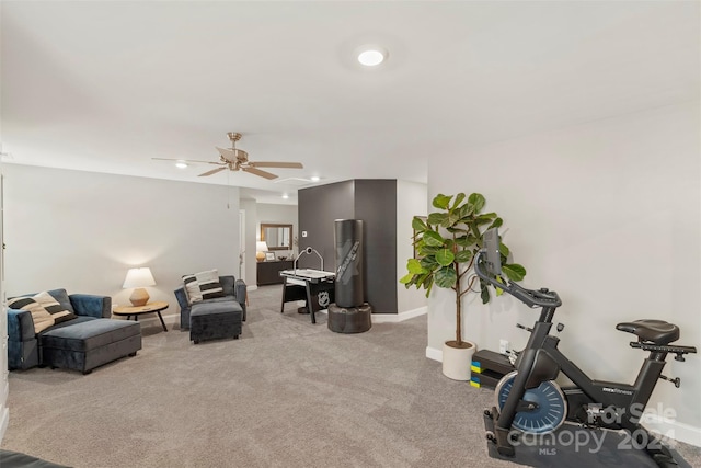 interior space featuring light carpet and ceiling fan