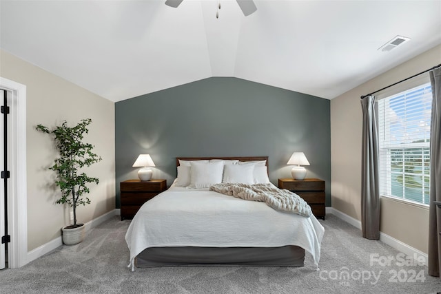 bedroom featuring ceiling fan, light colored carpet, and vaulted ceiling