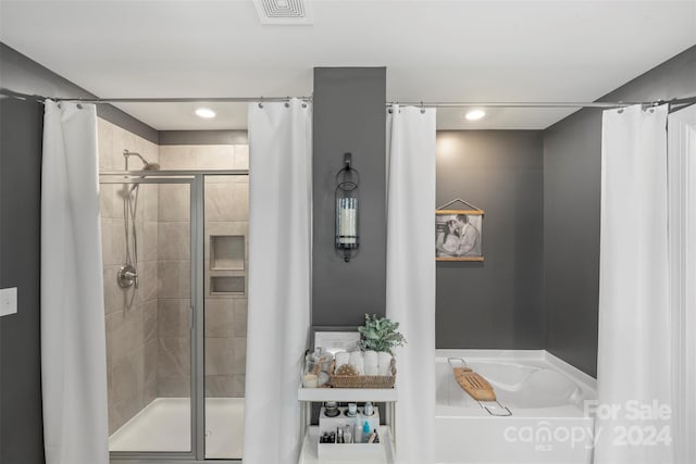 bathroom with shower with separate bathtub