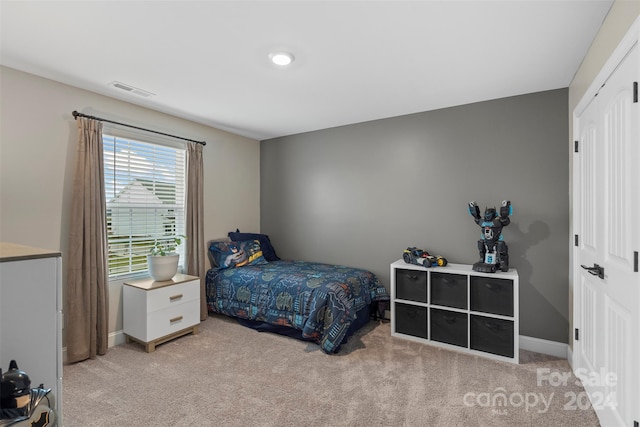 carpeted bedroom featuring a closet