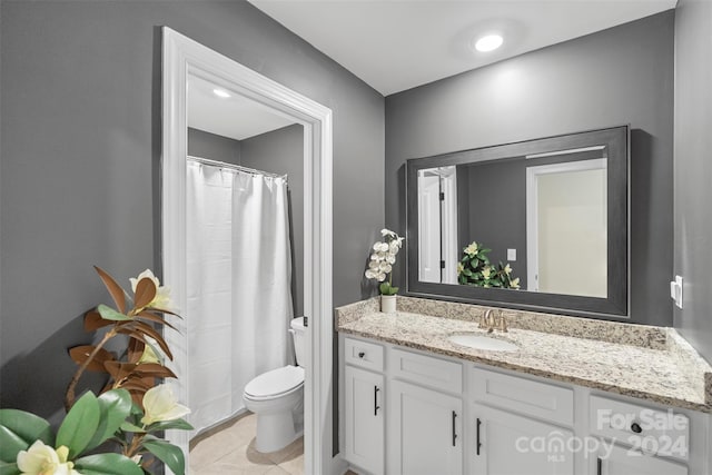 bathroom with tile patterned floors, vanity, and toilet