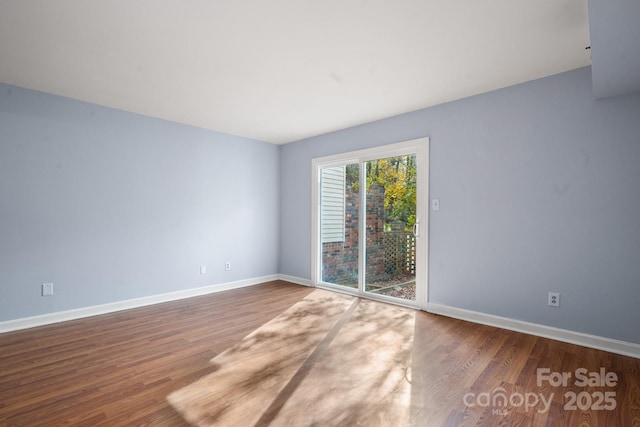 empty room with hardwood / wood-style flooring