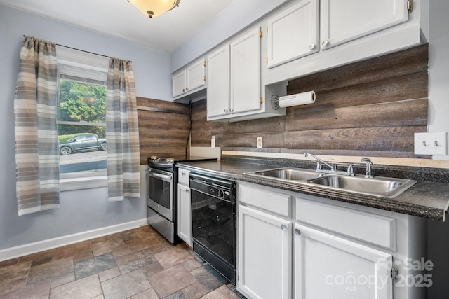 kitchen with wood walls, white cabinets, stainless steel electric stove, sink, and black dishwasher