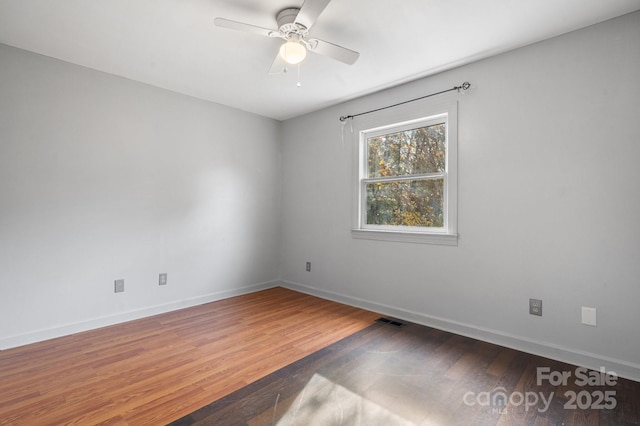 empty room with ceiling fan and hardwood / wood-style floors