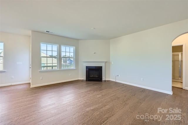 unfurnished living room with dark hardwood / wood-style flooring