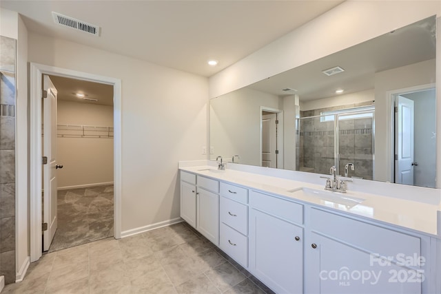 bathroom featuring vanity and a shower with door