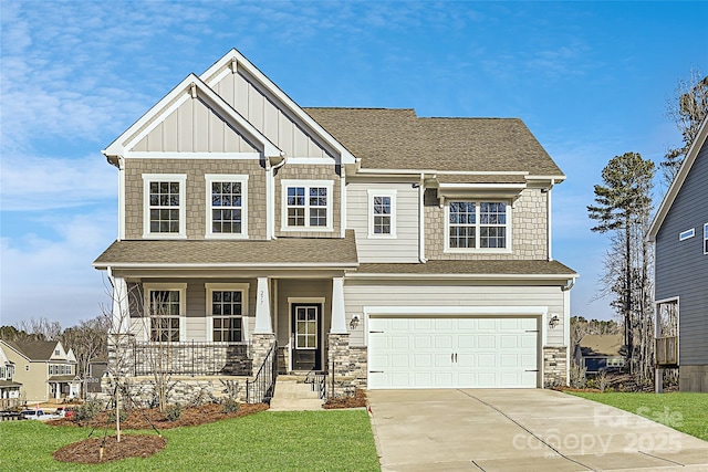 craftsman inspired home with a garage, covered porch, and a front yard